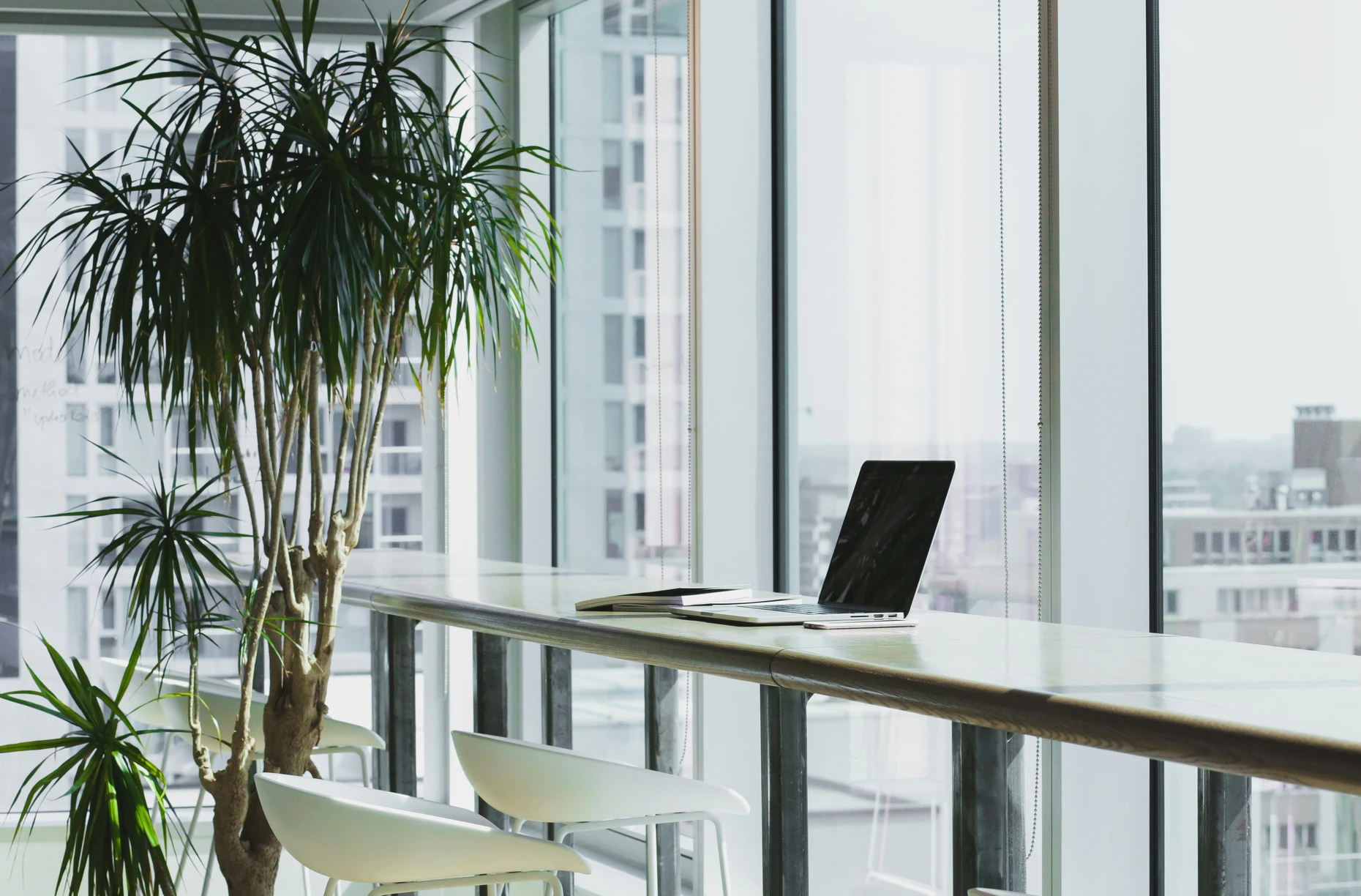 Quiet window-side workspace with a laptop